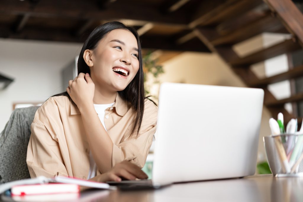 woman laughing in online meeting